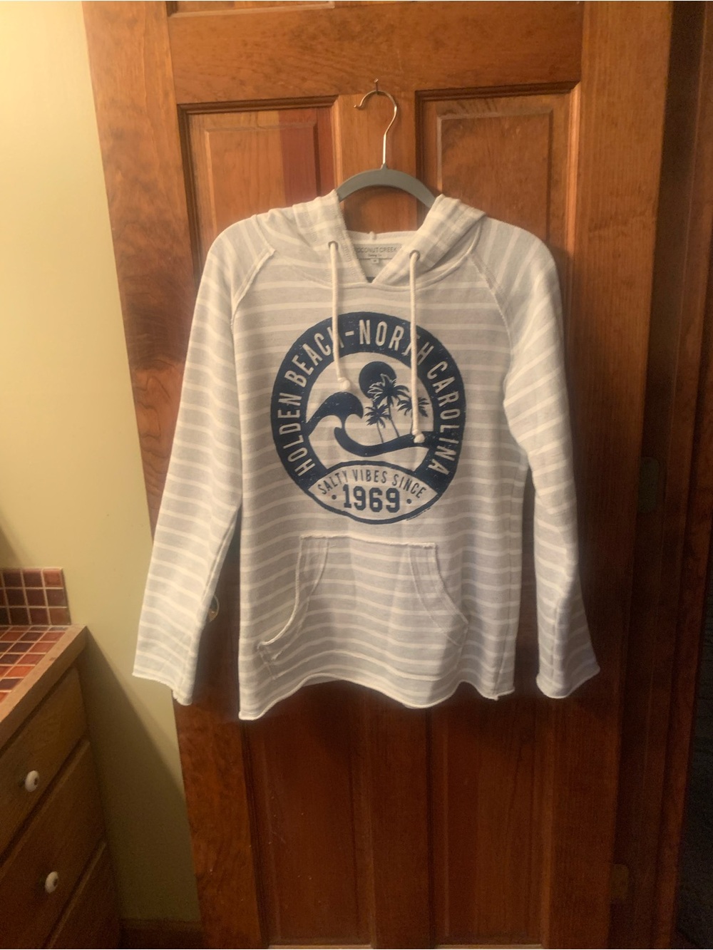 Coconut Creek Trading Co, GRAY and WHITE stripe hooded pullover, size Medium.